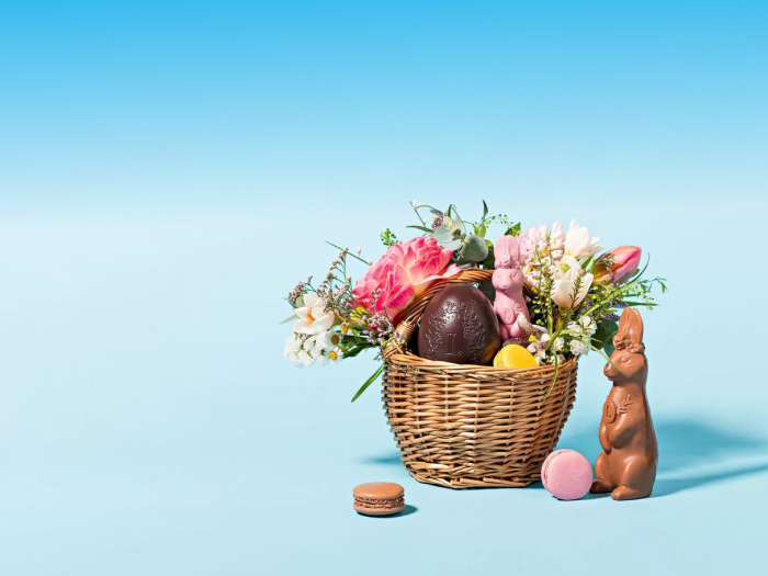 Easter basket with a chocolate bunny on a blue and white background