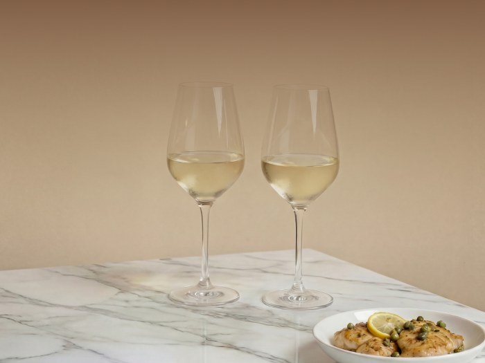 Chicken with capers and lemon and two glasses of white wine